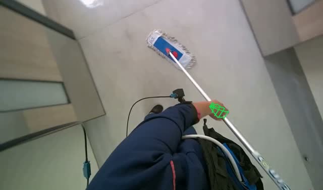 Mopping floor with flat mop: egocentric robotics sample