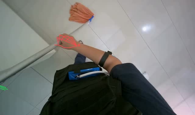 Mopping floor with orange mop: egocentric robotics sample