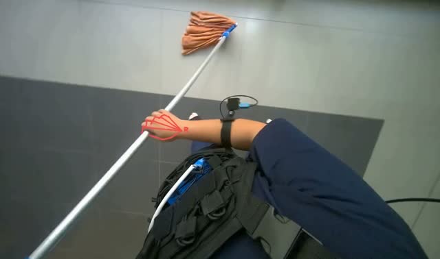Mopping tiled floor with string mop: egocentric robotics sample