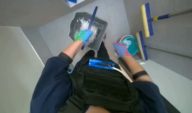 Removing cloth from bucket and emptying water: egocentric robotics sample