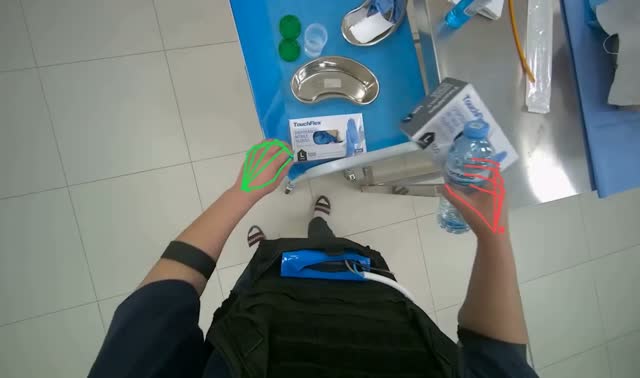 Clearing medical supplies from metal table into bin: egocentric robotics sample