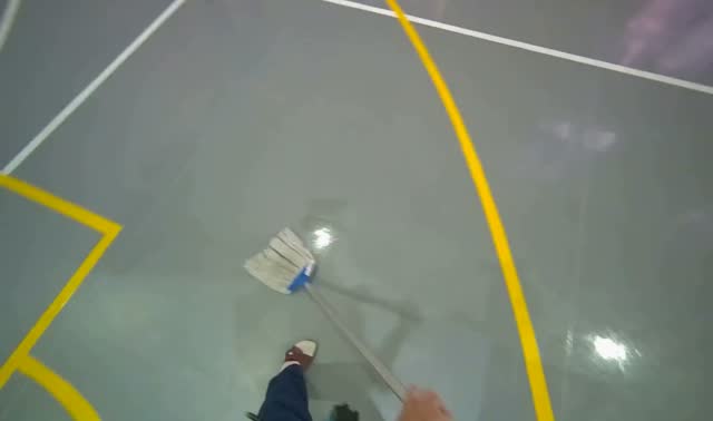 Mopping grey sports hall floor: egocentric robotics sample