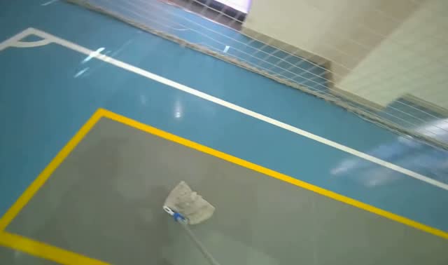 Mopping blue sports hall floor: egocentric robotics sample