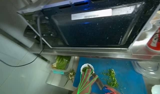 Scooping chopped green onions into bowl: egocentric robotics sample