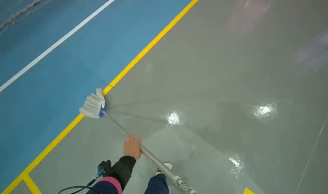 Mopping grey sports hall floor: egocentric robotics sample