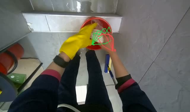 Wringing cleaning cloth in red bucket: egocentric robotics sample