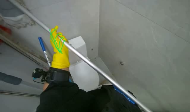 Mopping restroom walls with mop: egocentric robotics sample