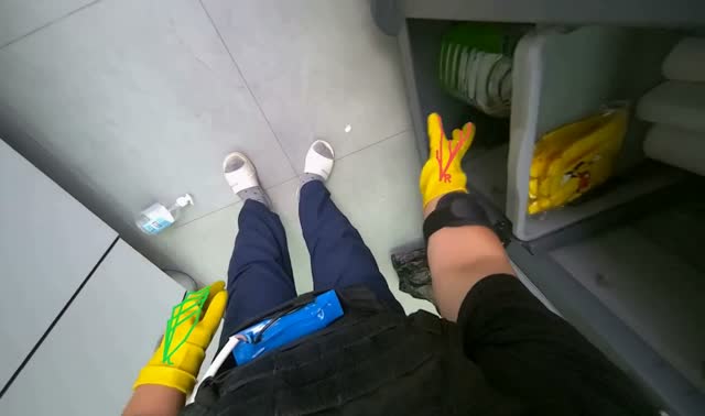 Organizing cleaning supplies on table: egocentric robotics sample