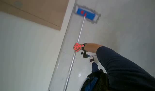 Mopping floor with flat mop: egocentric robotics sample