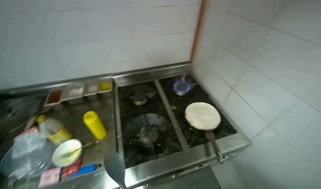 Pressing tortilla onto mixture in pan: egocentric robotics sample